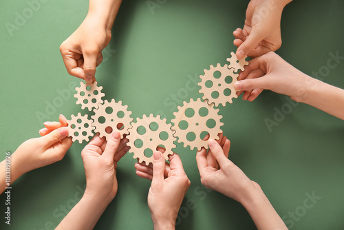 Hands holding wooden gears ...