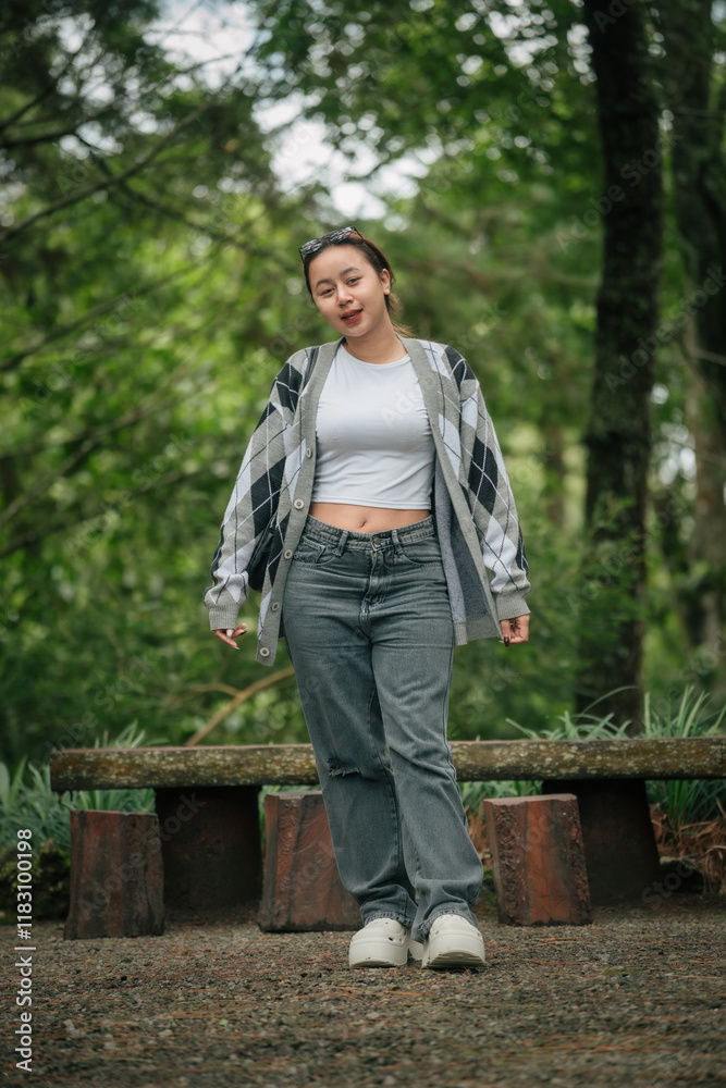 Happy Woman in Casual Outfit Enjoying a Peaceful Forest Setting Outdoors Happy Woman in Casual Outfit Enjoying a Peaceful Forest Setting Outdoors