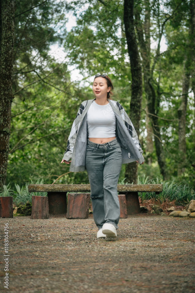 Happy Woman in Casual Outfit Enjoying a Peaceful Forest Setting Outdoors Happy Woman in Casual Outfit Enjoying a Peaceful Forest Setting Outdoors