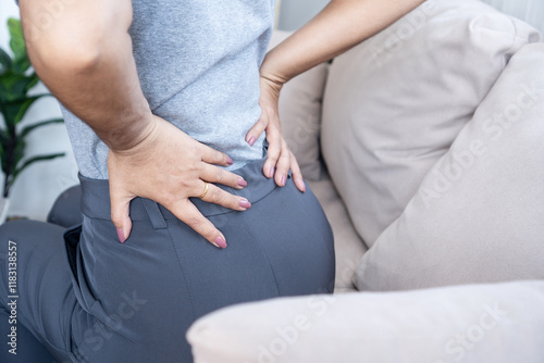Canvastavla Woman suffering from lower back pain due to muscle strain, poor posture, or prol