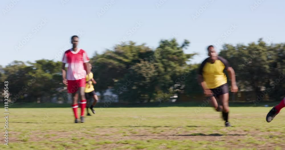 Playing soccer, two men in action near goalpost on grassy field Playing soccer, two men in action near goalpost on grassy field