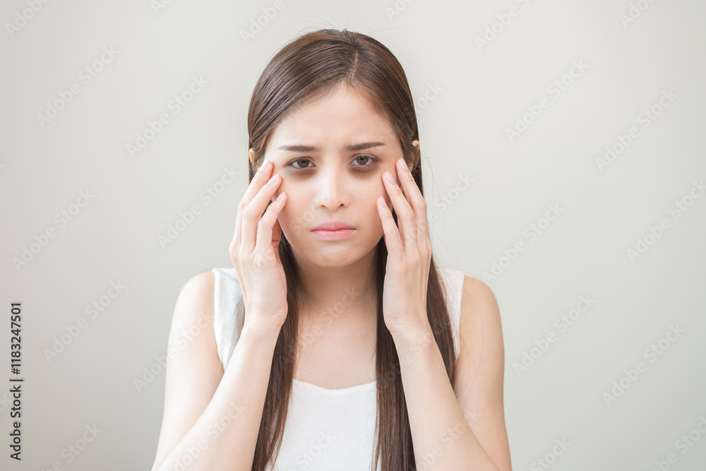 Bored, insomnia asian young woman, girl looking at camera, hand touching under eyes with problem of black circles or panda puffy, swollen and wrinkle on face. Sleepless, sleepy healthcare person. Bored, insomnia asian young woman, girl looking at camera, hand touching under eyes with problem of black circles or panda puffy, swollen and wrinkle on face. Sleepless, sleepy healthcare person.