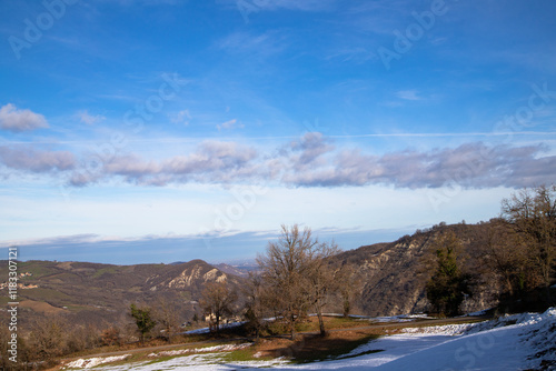 Snow-covered Emilian hills, peaceful countryside, scenic winter view, tranquil nature, picturesque snowy rural landscape. photo