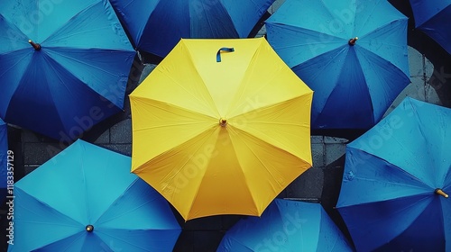 Yellow Umbrella Among Blue Umbrellas