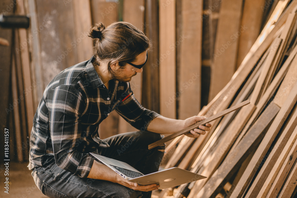 Carpenter worker working in wood workshop selecting timber wood plank for wooden furniture project Carpenter worker working in wood workshop selecting timber wood plank for wooden furniture project