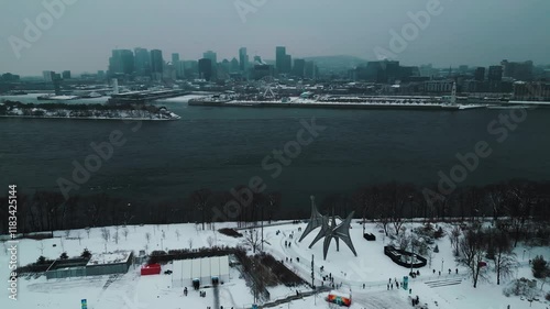 aerial shot around Jean Drapeau Park in Montreeal City with the Saint Laurent River and Montreal city skyline in the background on a moody day during winter season, Quebec Region, Canada photo