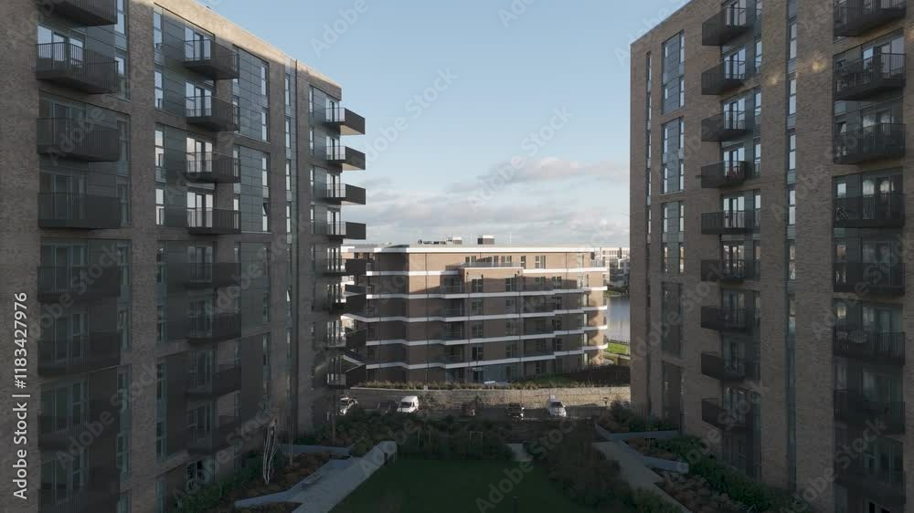 Fly-in to a chic penthouse residence beside a tranquil lake, highlighting upscale architecture, private balconies, and scenic serenity Fly-in to a chic penthouse residence beside a tranquil lake, highlighting upscale architecture, private balconies, and scenic serenity