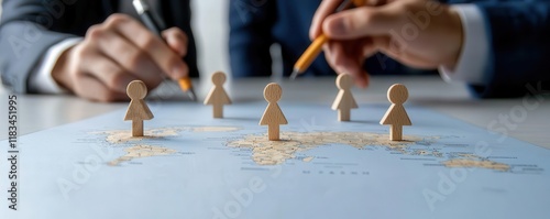 Sales leader marking territories on a printed map while a team discusses goals in the background