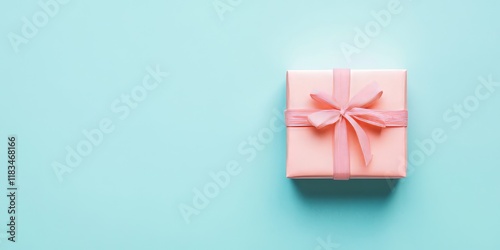 Handmade gift design concept for Valentine s Day and Mother s Day featuring a wrapped gift box isolated on a pastel light blue background, showcasing creativity in gift design and presentation. photo