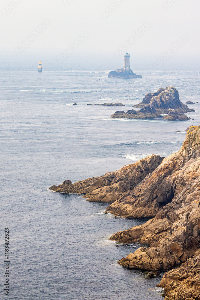 Rocky seashore with a lighthouse on a rock on the sea Rocky seashore with a lighthouse on a rock on the sea