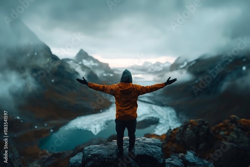 Solitary figure silhouetted against a breathtaking mountain vista arms outstretched in a gesture of exultation rugged terrain dotted with jagged rock formations and pristine snowfields