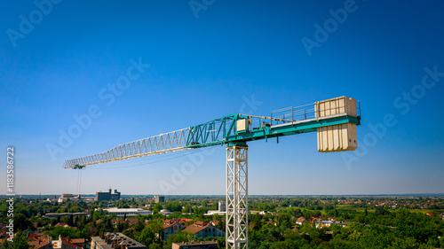 The upper part of construction tower crane with counterweights photo