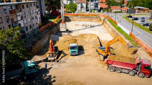 Photography Ariel view excavator is loading a truck with ground on building site