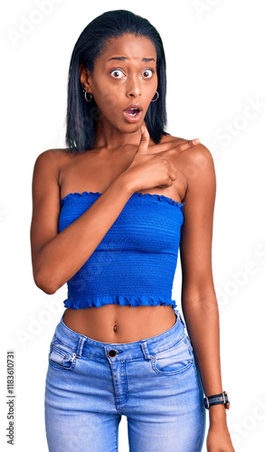 Young african american woman wearing casual summer clothes surprised pointing with finger to the side, open mouth amazed expression. photo