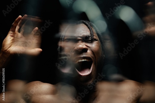Εκτύπωση καμβά Portrait of desperate Black man fiercely shouting with raised hands experiencing