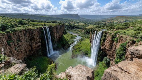 Fototapeta Naklejka Na Ścianę i Meble -  Majestic Ouzoud Waterfalls cascading into lush green valley, stunning view