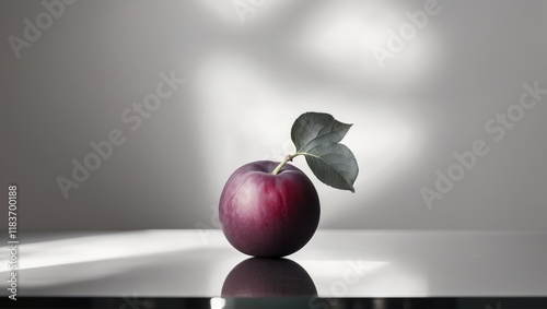 Crafted Plum with Leaf and Reflective Surface photo