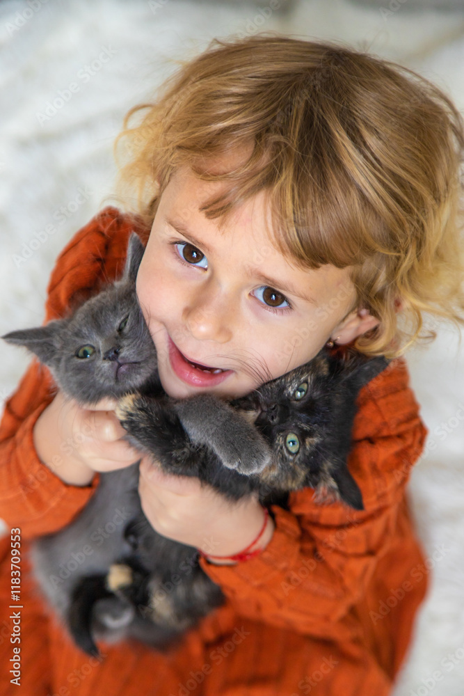Child playing with kittens at home. Selective focus. Child playing with kittens at home. Selective focus.