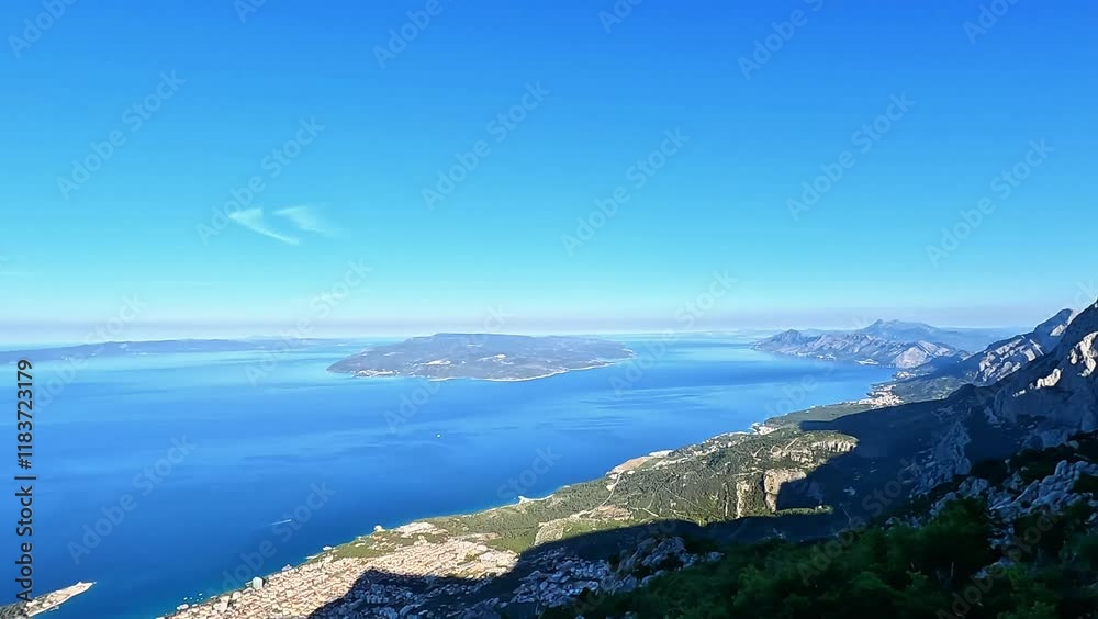 View from the top of the mountain to the city of Makarska, Croatia. A tourist shows a first-person view View from the top of the mountain to the city of Makarska, Croatia. A tourist shows a first-person view