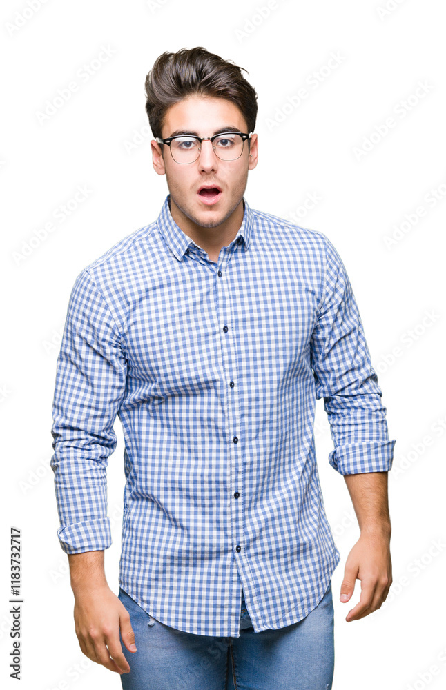 Fototapeta premium Young handsome man wearing glasses over isolated background afraid and shocked with surprise expression, fear and excited face.