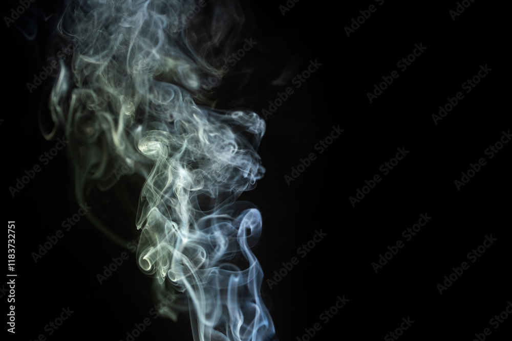 Swirling white smoke against a dark background creates a mysterious and captivating effect Swirling white smoke against a dark background creates a mysterious and captivating effect