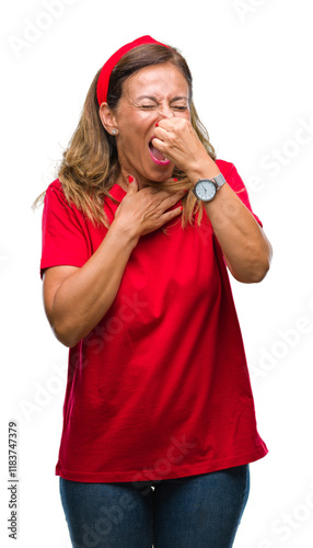 Middle age senior hispanic woman over isolated background smelling something stinky and disgusting, intolerable smell, holding breath with fingers on nose. Bad smells concept.