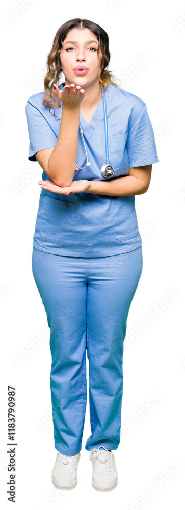 Young adult doctor woman wearing medical uniform looking at the camera blowing a kiss with hand on air being lovely and sexy. Love expression. Young adult doctor woman wearing medical uniform looking at the camera blowing a kiss with hand on air being lovely and sexy. Love expression.