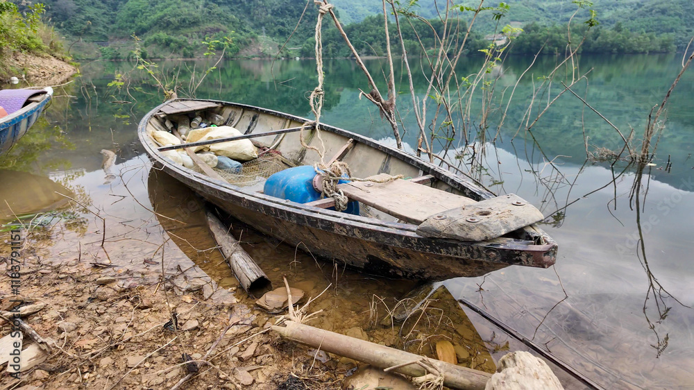 A rustic wooden boat rests on a serene lakeshore, symbolizing tranquility and escape, ideal for Earth Day concepts A rustic wooden boat rests on a serene lakeshore, symbolizing tranquility and escape, ideal for Earth Day concepts