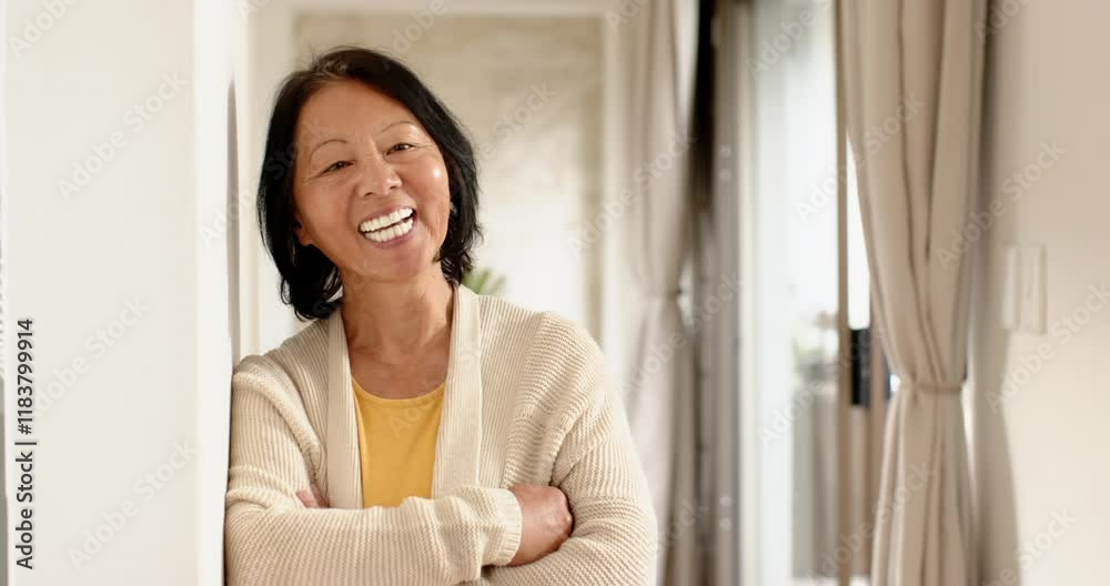 Smiling senior woman enjoying peaceful moment at home during Christmas season Smiling senior woman enjoying peaceful moment at home during Christmas season
