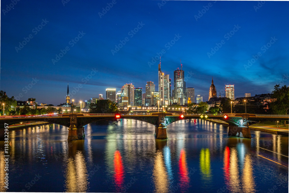 Skyline view from a bridge. Metropolis with skyscrapers reflected in a river. City of Frankfurt am Main, Germany Skyline view from a bridge. Metropolis with skyscrapers reflected in a river. City of Frankfurt am Main, Germany