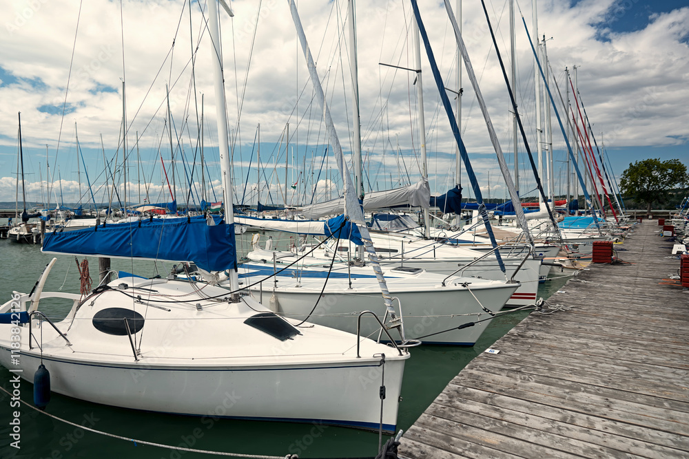 Wooden walkway with moored sailboats in the harbour of Lake Balaton, Hungary Wooden walkway with moored sailboats in the harbour of Lake Balaton, Hungary