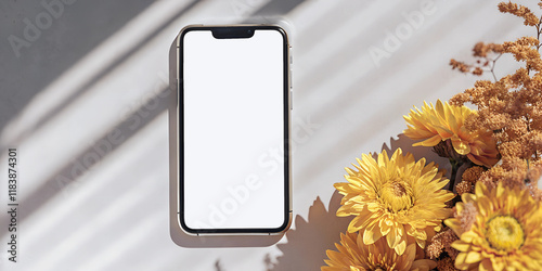 Smartphone mockup with a blank white screen and golden-yellow flowers casting soft shadows on a minimalist background. Perfect for sunny, seasonal designs or app showcases.