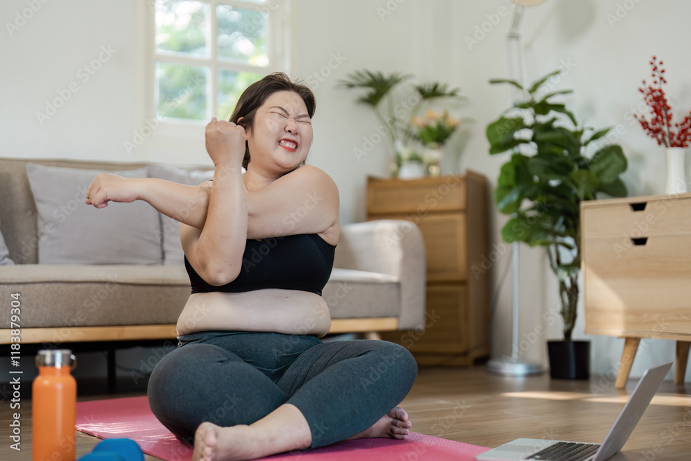 Confident Overweight Woman Exercising at Home with Yoga Mat and Laptop in Bright Living Room Setting Confident Overweight Woman Exercising at Home with Yoga Mat and Laptop in Bright Living Room Setting