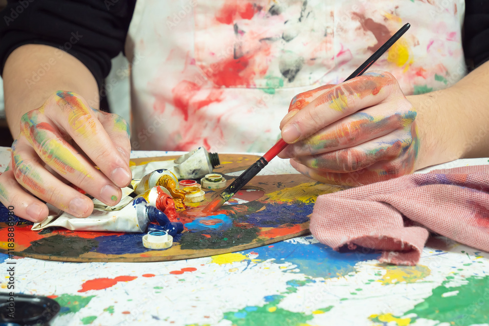 Painter holding paintbrushes in his hands, close-up Painter holding paintbrushes in his hands, close-up