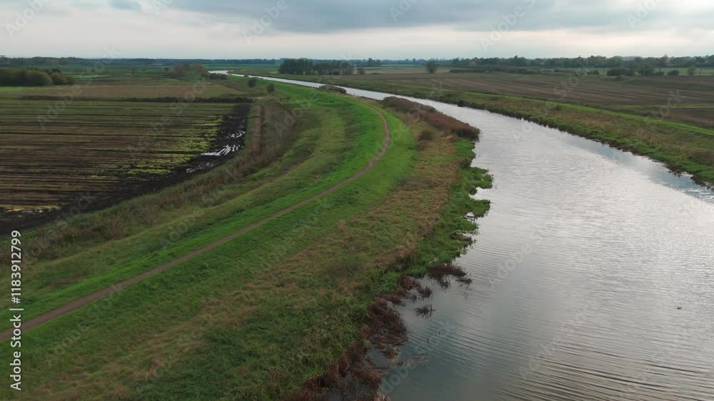 A serene riverside view of Ely River with lush greenery and vast open fields A serene riverside view of Ely River with lush greenery and vast open fields