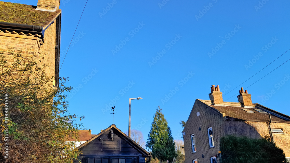 Fototapeta premium Aerial view of English countryside village with charming tiled rooftops.