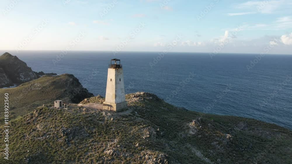 Lighthouse on a rocky coastline during a serene sunset at Los Roques Lighthouse on a rocky coastline during a serene sunset at Los Roques