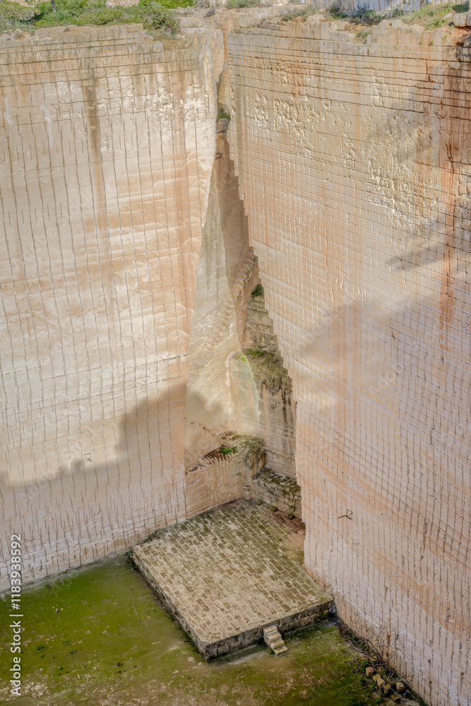A stunning view of the intricate stone carvings and structures at Lithica sandstone quarries, vacation spot, Famous quarry near the town of Ciutadella, Minorca, Spain.