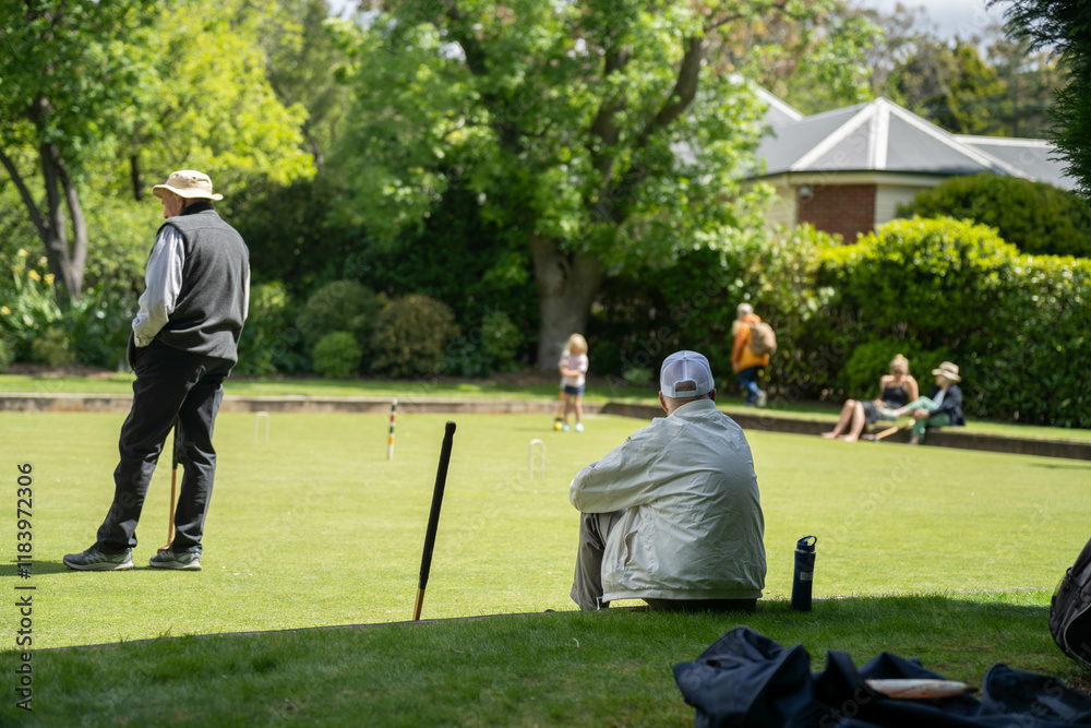 family playing croquet in a lawn playing field in australia family playing croquet in a lawn playing field in australia