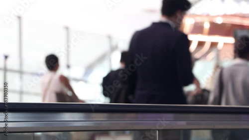 Handrail of moving walkway with people in airport terminal photo