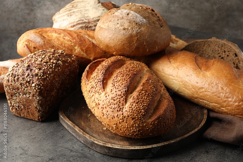 Different freshly baked bread loafs on grey table, closeup Different freshly baked bread loafs on grey table, closeup