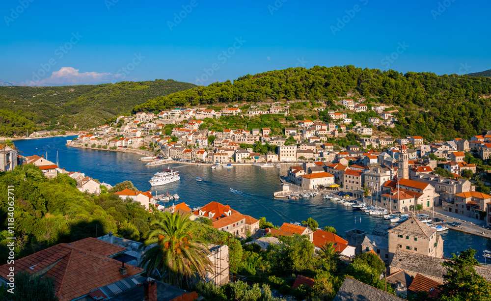 The Pučišća fjord on Croatian vacation island of Brač is a popular tourist destination. Panorama of the idyllic seaside resort on the Adriatic Sea in Dalmatia with harbour, town center and scenery. The Pučišća fjord on Croatian vacation island of Brač is a popular tourist destination. Panorama of the idyllic seaside resort on the Adriatic Sea in Dalmatia with harbour, town center and scenery.