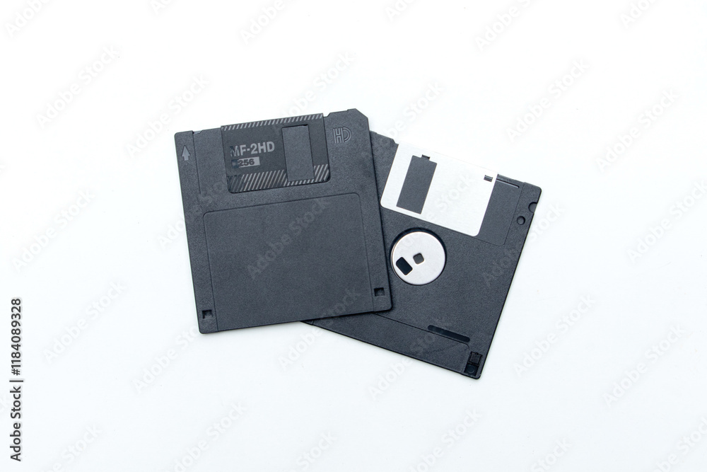 A nostalgic look at a floppy disk, elegantly displayed on a clean white backdrop. A nostalgic look at a floppy disk, elegantly displayed on a clean white backdrop.