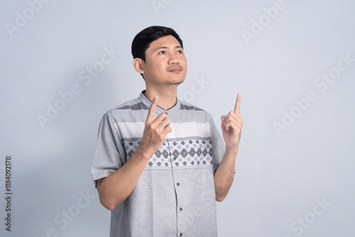 Muslim man pointing finger for Ramadan with Smile expression on isolated white background
