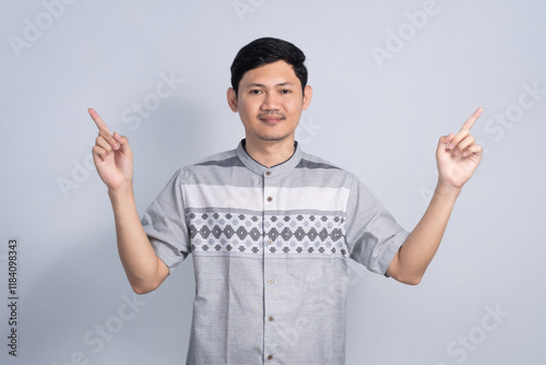 Muslim man pointing finger for Ramadan with Smile expression on isolated white background