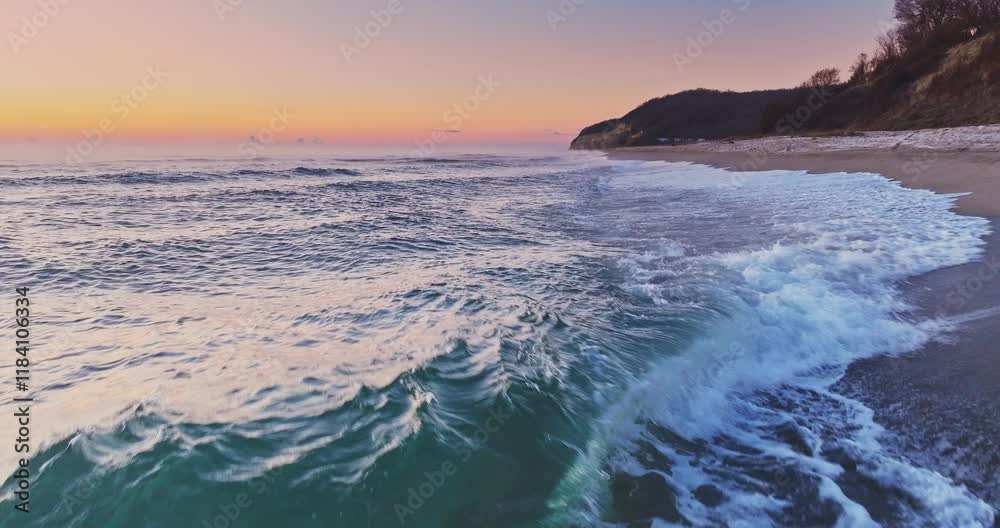 Flying over rolling waves to the wild beach shore, beautiful sea sunrise sunset landscape