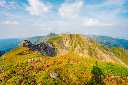 Hiking in Fagaras mountains on Iezerul Caprei peak over Transfagarasan serpentine road carpathian mountains. Mountains landscape photo