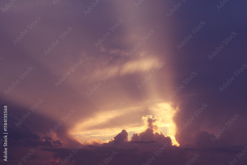 Fototapeta premium Dramatic sky with the sun shining behind clouds