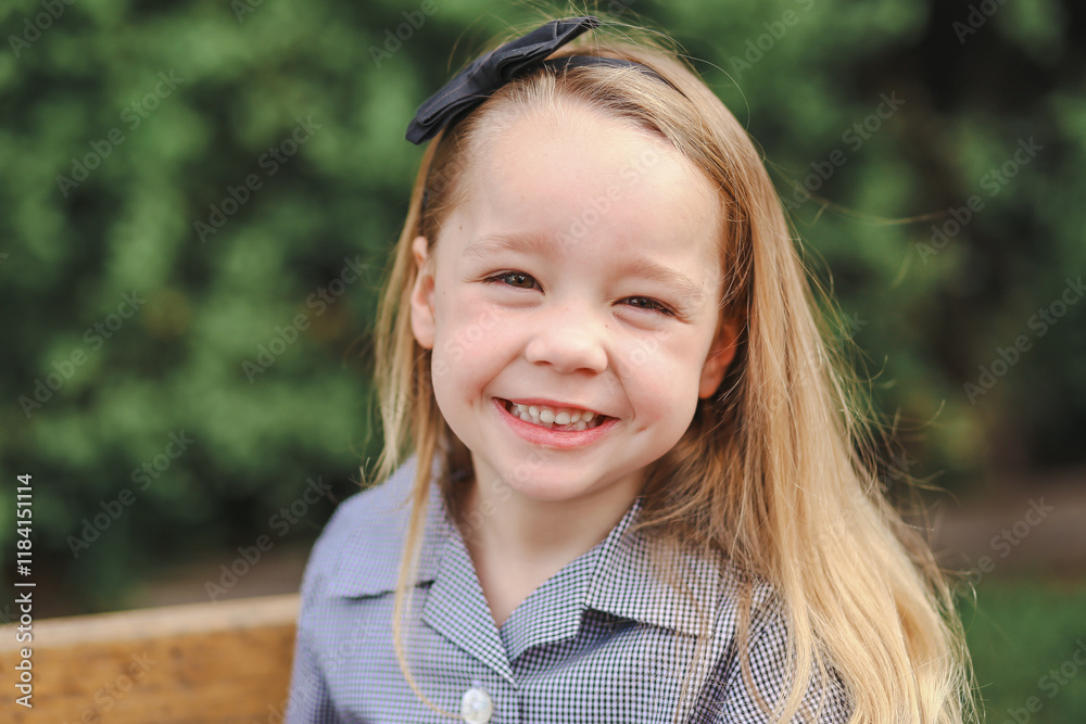 Outdoor portrait of little girl wearing school uniform smiling Outdoor portrait of little girl wearing school uniform smiling