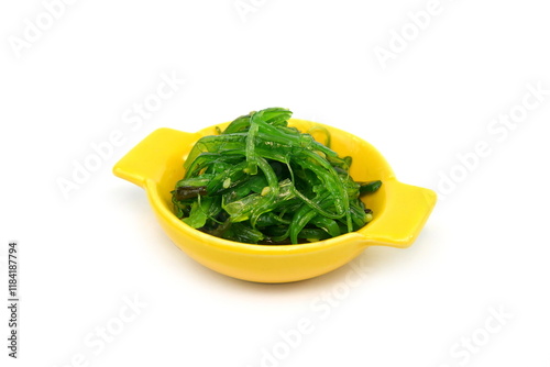 Heap of organic Japanese Wakame salad isolated on white background. Edible Green Algae, Sea Vegetable Isolated. Green Chuka Seaweed Salad Isolated on White Background. Edible Seaweed  photo